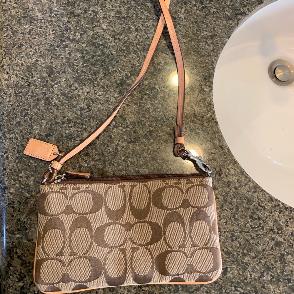 Tan logo Coach wallet. Never used.